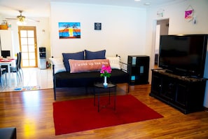 Another view of the living room, with laminate wood floors. 