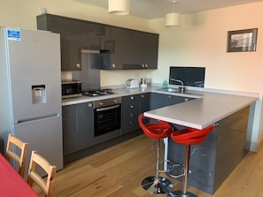 Kitchen with fridge freezer, washing machine and dishwasher