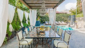 Outdoor dining area nearby the pool.