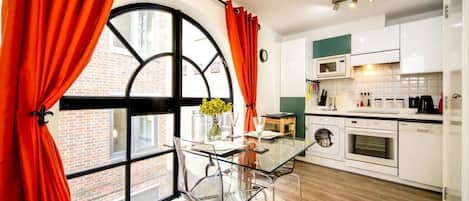 Bright and fully equipped kitchen with dining table