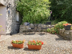 Garden patio. The path behind leads to 2 acres of private meadows to explore.