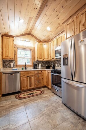 Full kitchen with granite countertopsNd stainless steel appliances