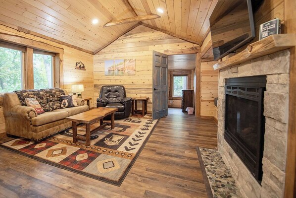 Living room with TV, fireplace,