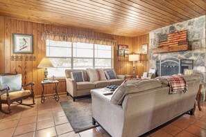 The spacious and comfortable living area includes a fireplace, which adds that perfect crackling warmth to chilly evenings!