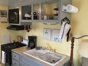 Gas cook-top, microwave, coffee pot, double sink, dishes, utensils, pots & pans