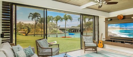 The family room w large TV and surround sound leads right out to lawn & water!