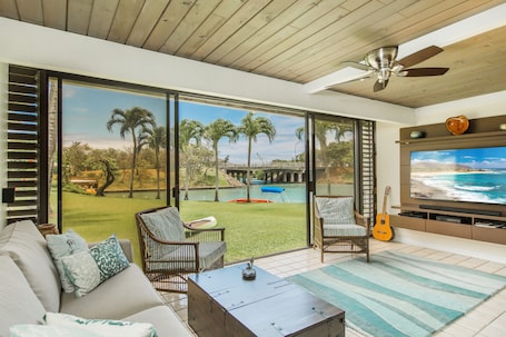 The family room w large TV and surround sound leads right out to lawn & water!