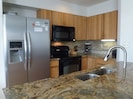 Remodeled kitchen with slab granite counters