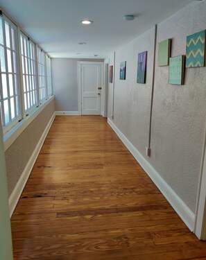 long sun room hallway with large antique windows