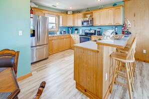 Expansive kitchen featuring stainless steel appliances.