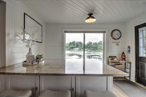 Spacious kitchen island seats 6 with beautiful view of the river.  