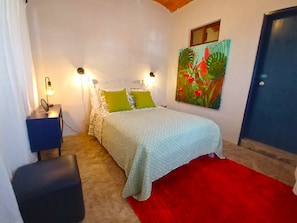 The Jardin bedroom with a pillow top double mattress and custom artwork. 