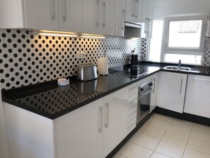 The kitchen with dishwasher, oven, hob microwave, fridge & freezer