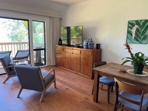 Spacious living room with extra seating near large smart TV.