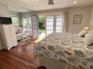 The main bedroom features a sumptuous king bed, a loveseat, and a walk-in closet