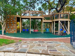 Elevated Deck with Playground underneath with commercial grade soft play surface