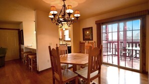 4-seater dining table with a sliding door towards the screened porch