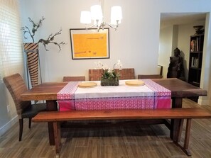 Dining area w/an organic slab table. Bench/chairs sits 10. Adjacent to Kitchn