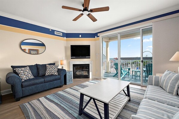 Cozy living area with gas fireplace, flat screen TV, and a stunning view of  the Atlantic Ocean!