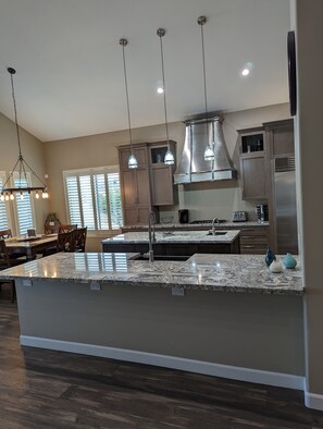 double island kitchen with double oven and wine cooler