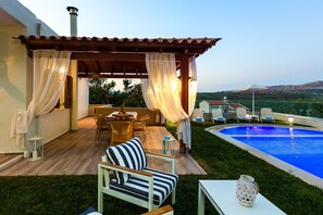 A lovely outdoor sitting area and a shaded outdoor dining area with pergola.