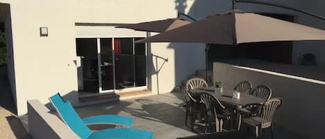 Terrasse du logement, bbq gaz, parasols, transats, table et chaises