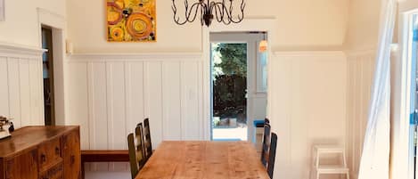 Sunlit Dining Room in the center of everything. French doors onto expansive deck