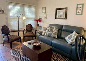 Living room with leather sofa and Barbara Barry X- back chairs