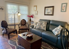 Living room with leather sofa and Barbara Barry X- back chairs