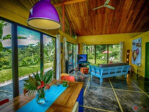 Dining table, seats 6 with a view of front yard, jungle and ocean. 