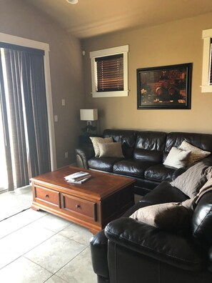 Main floor living room walks out to grass and water view