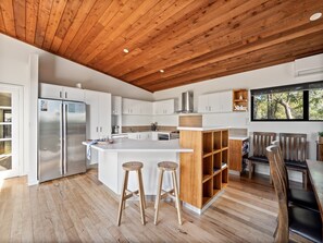 A gas cooktop, electric oven, Nespresso machine, and plenty of counter space make meal prep a breeze.