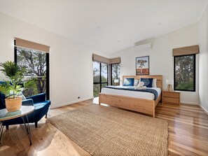 Featuring a king bed, private deck access, and an ensuite with a soaking bath, the primary bedroom is a true retreat.