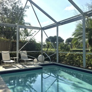 Screened in patio with views of the lake and golf course.