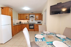 Dining area with seating for four and fully outfitted kitchen