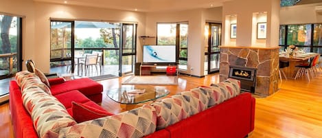 Open the doors wide to extend your living space onto the deck, where glowing sunsets meet indoor comfort and a roaring winter fire.