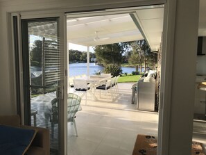 Indoor/outdoor flow from living areas to deck and coastal lifestyle comforts.