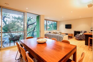 Gather around the island bench or eight-seater dining table in the stylish kitchen—perfect for shared meals and morning brekkie.