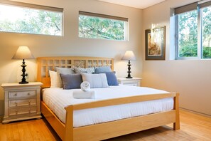 Relax in the queen-bedded primary bedroom on the first floor with soft lighting and access to a luxurious private en-suite with bath and shower.