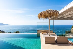 Infinity pool, modern sun beds and hot tub