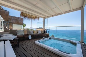 The hot tub enjoys unobstructed sea views.