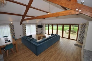 Dining & lounge area with sofa, 42" smart TV & bi-fold doors