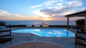 On the waterfront, villa with path leading to a small sandy beach.