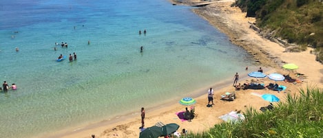 Sandy, cute Spartia beach: shallow, warm waters, few rocks around for snorkeling