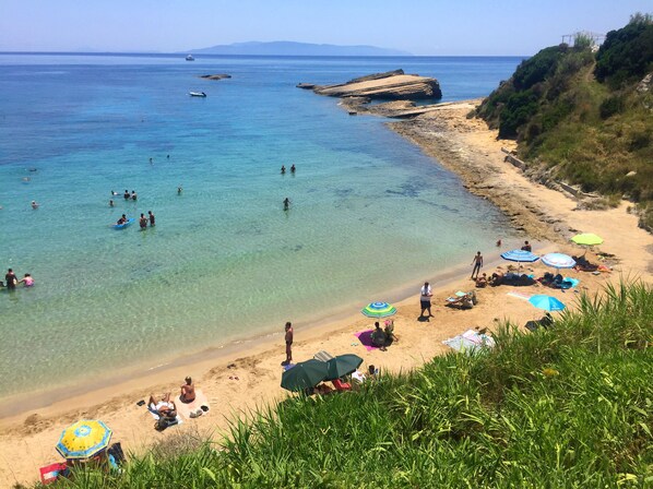 Sandy, cute Spartia beach: shallow, warm waters, few rocks around for snorkeling