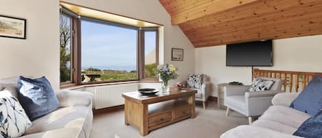 Comfy and cosy sitting room looking over St Brides bay.