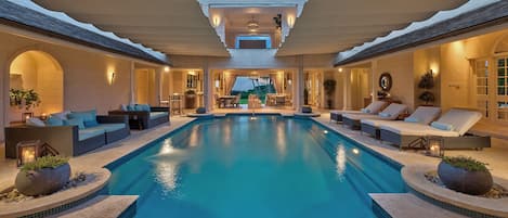 Indoor, open-air pool with retractable canopy.