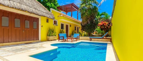 Mariposa has a palapa style roof and doors open to the pool.