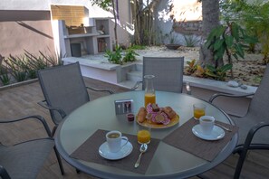 Shaded patio and grill in the back of Casa Pakal.