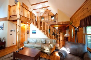 Super cozy couch, stairs to the master suite and skylight above the master bed